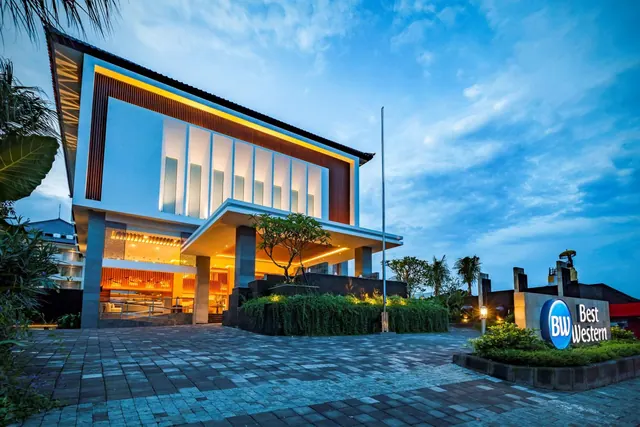 The exterior of a two-storey Best Western hotel building at dusk, with its lit entrance canopy and paved forecourt.