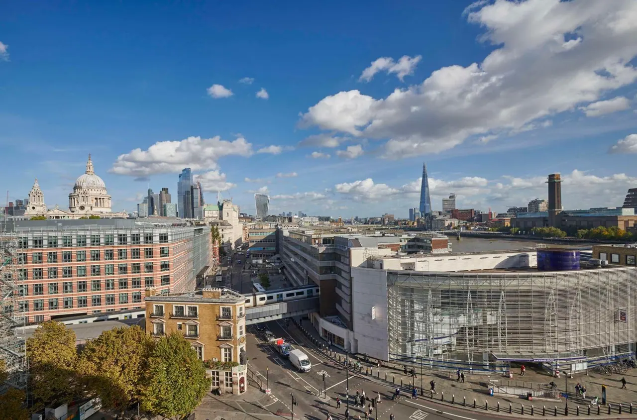 Elevated view over central London showing St Paul's Cathedral, the Shard, the River Thames and buildings and streets below.