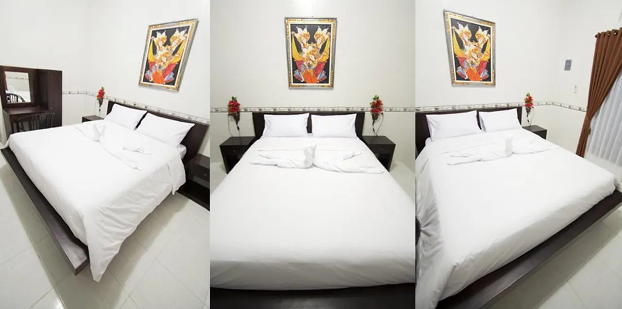 The photos show a bedroom with a made white double bed, framed wall art, and a dark wood vanity table on the left.